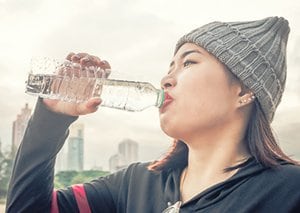 Women drinking bottled water.