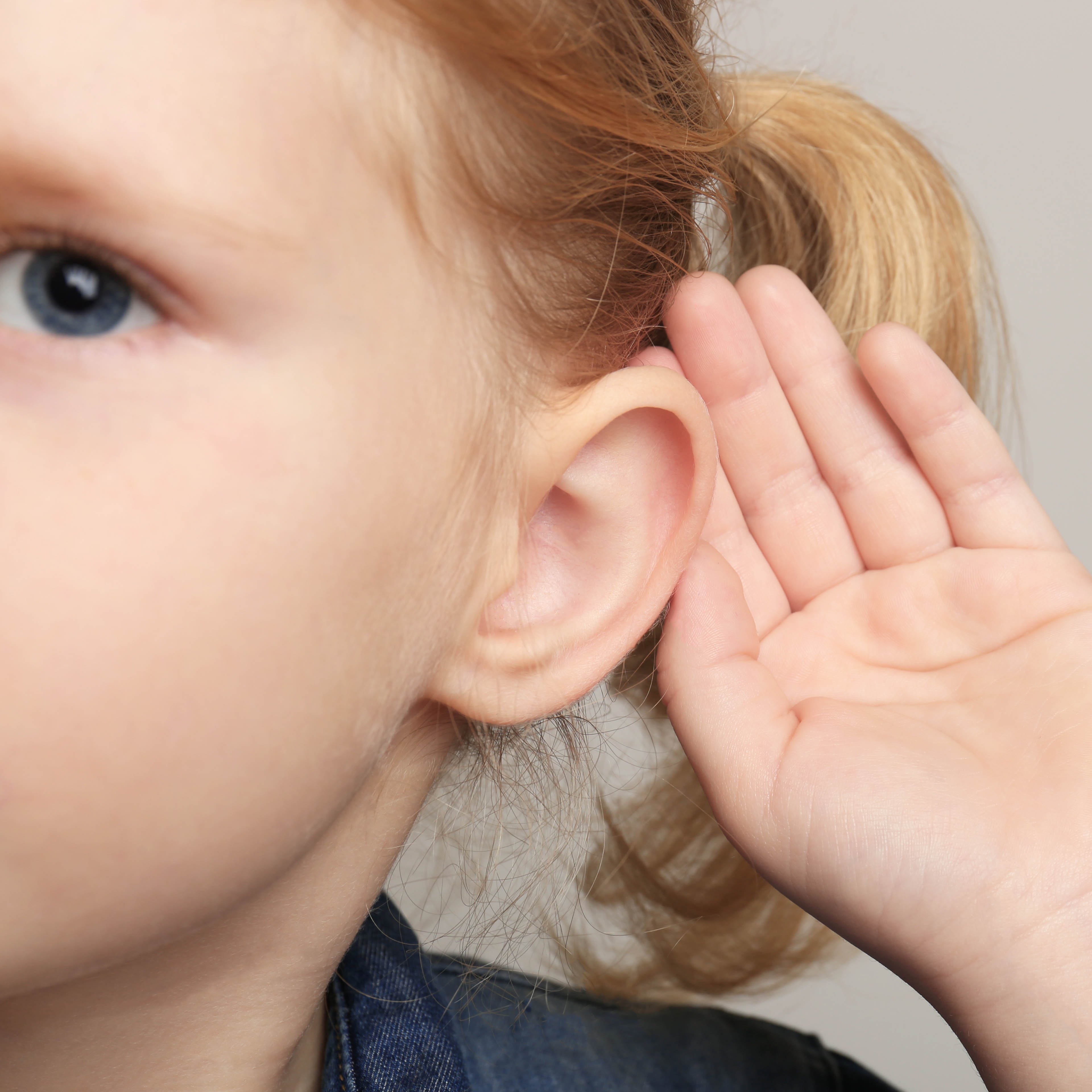 Little Girl Holding Hand Behind Ear