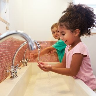 School kids washing hands to prevent flu.