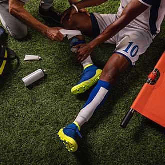 Coach helps player during soccer game.