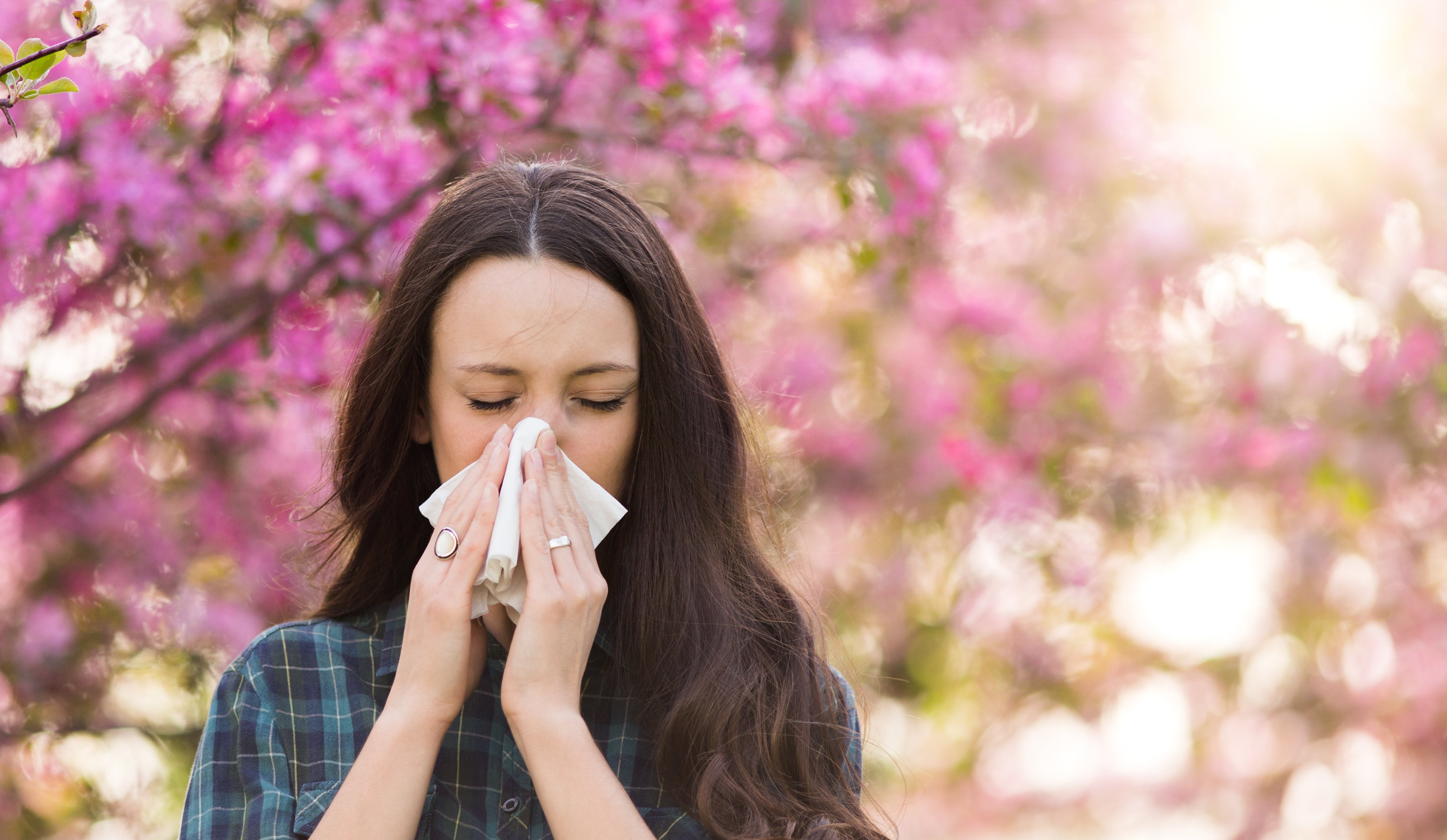 Woman Sneezing into a Tissue